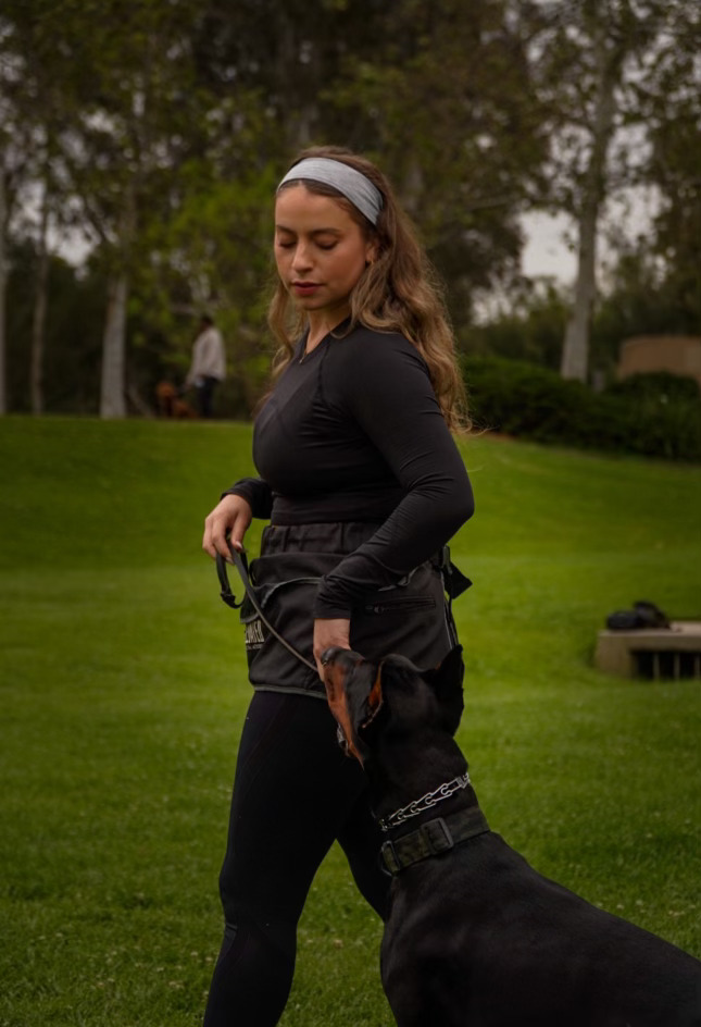 Dog owner practicing leash handling with her dog during training