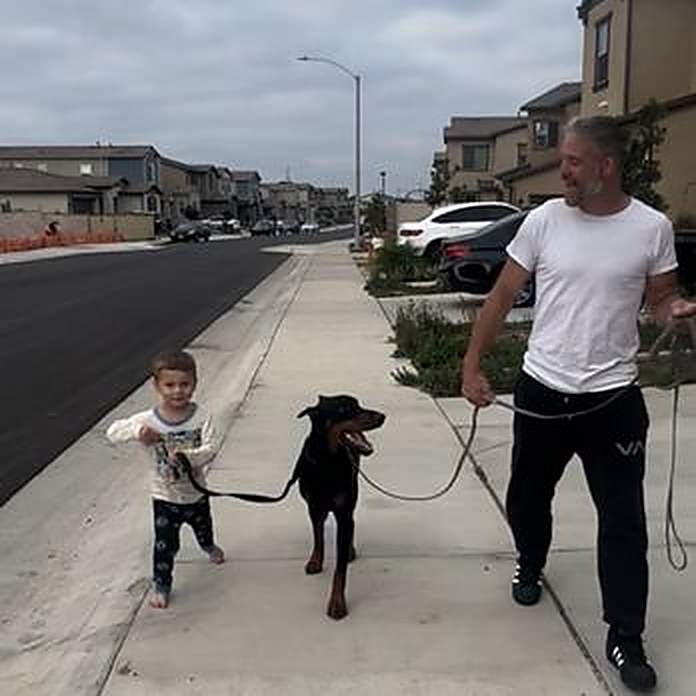 Child and handler walking a trained Doberman on a private lesson leash walk